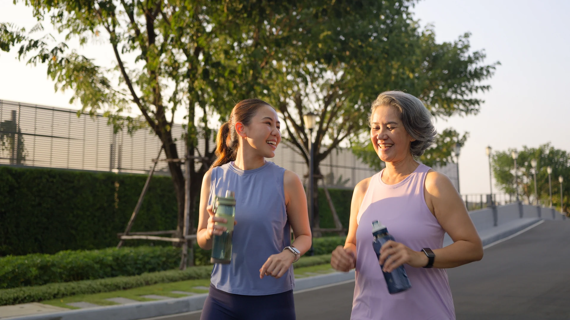 Mother and daughter walking together outdoors